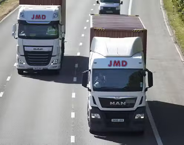 Photo of JMD lorries on road